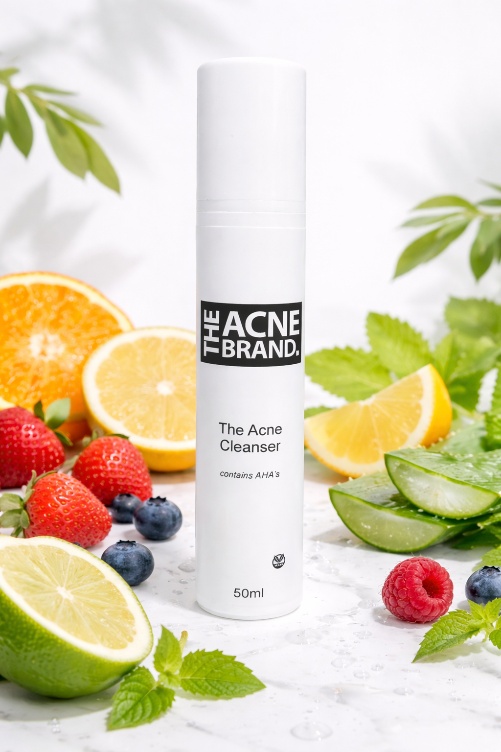 The Acne Serum from the plant-based acne skincare range on a marble surface with fruits and leaves.